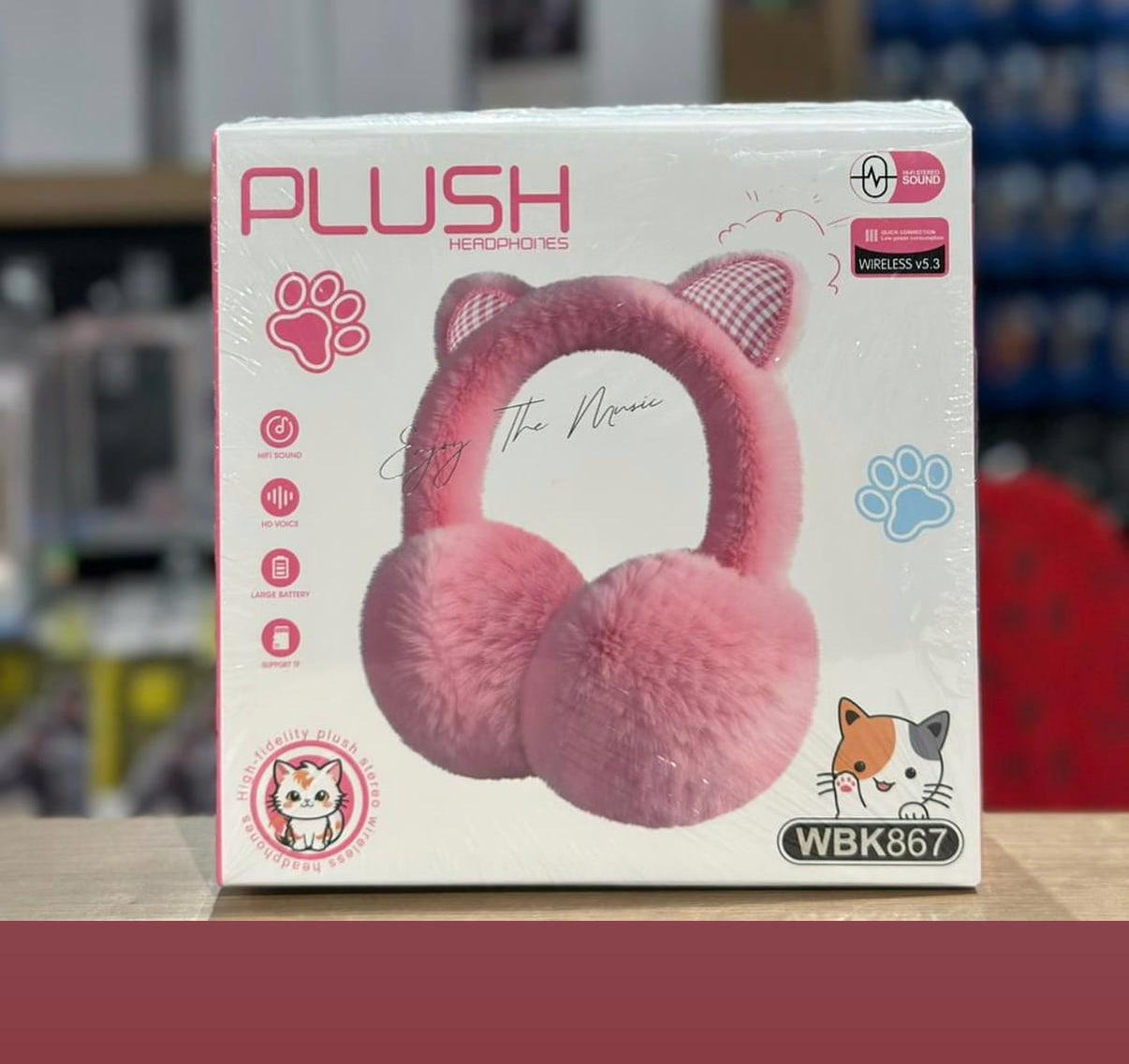 Box of pink plush headphones with paw prints and a cat design on a blurred background