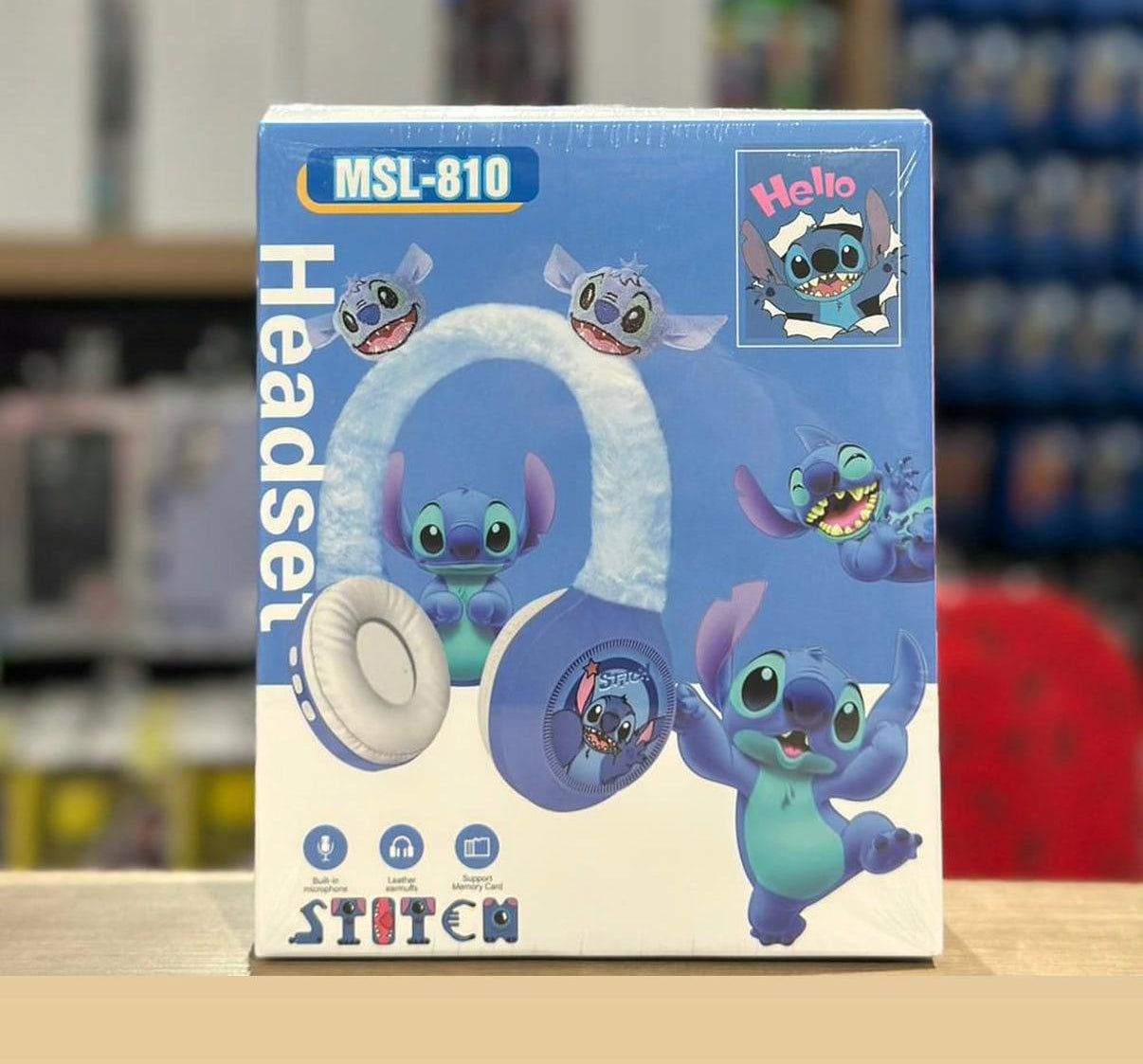 Box of Stitch-themed headphones with cartoon characters on a blurred background